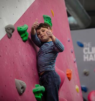 Junior climber giving thumbs up