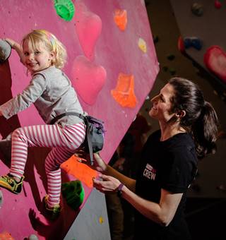 Little girl climbing with crew member
