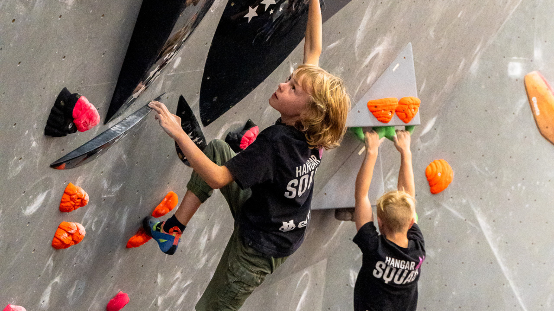 A young boy on a climbing wall